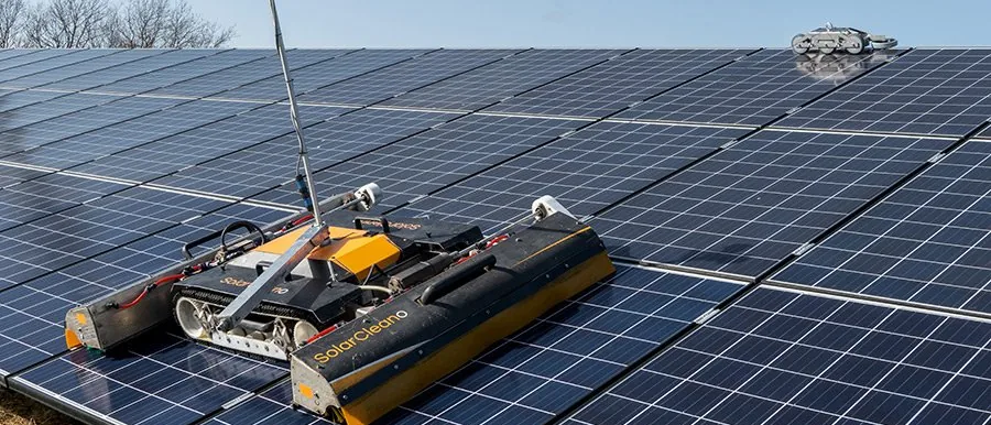 An autonomous cleaning robot crossing a solar array